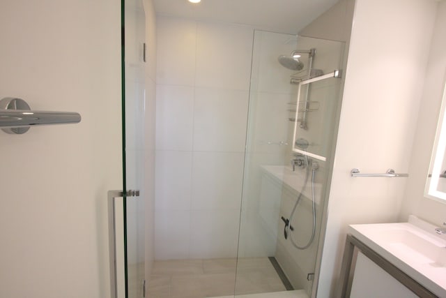 bathroom with an enclosed shower and vanity