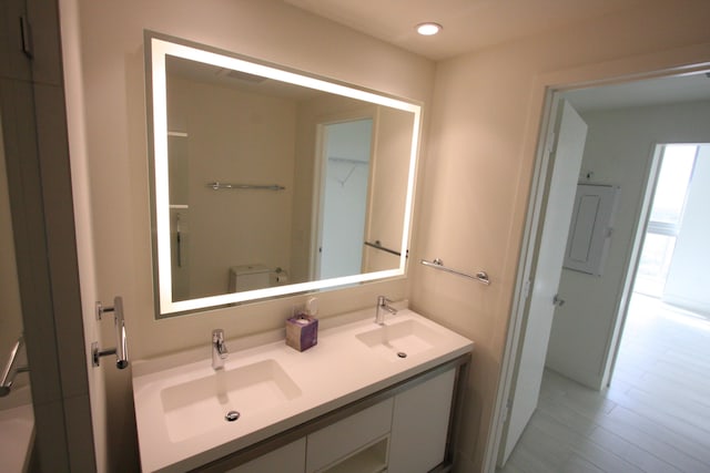 bathroom featuring vanity, toilet, and hardwood / wood-style flooring