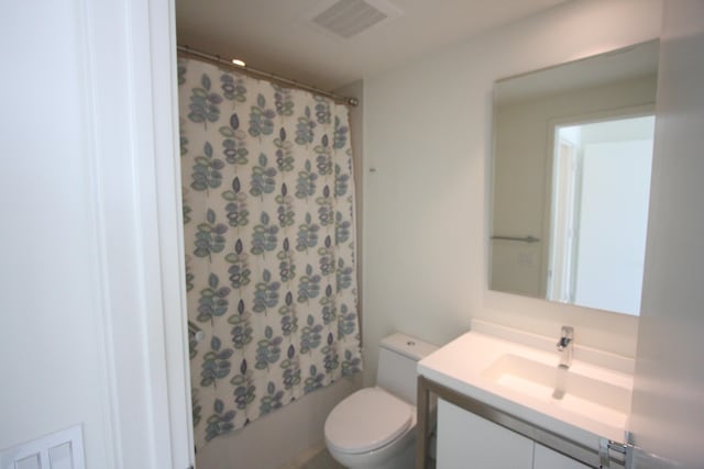 full bathroom with vanity, toilet, and shower / bath combo with shower curtain