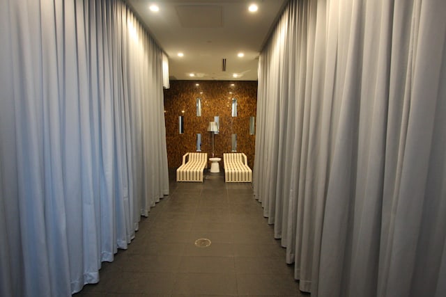 hallway featuring dark tile patterned flooring