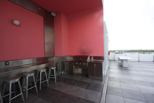 view of patio / terrace featuring an outdoor bar and grilling area