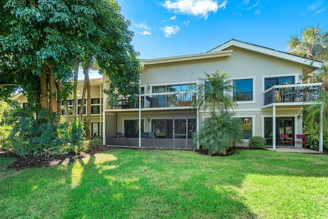 rear view of property featuring a yard