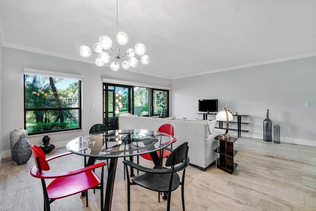 dining space featuring an inviting chandelier, light hardwood / wood-style flooring, and ornamental molding