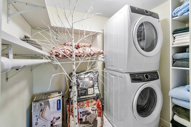 laundry room with stacked washing maching and dryer