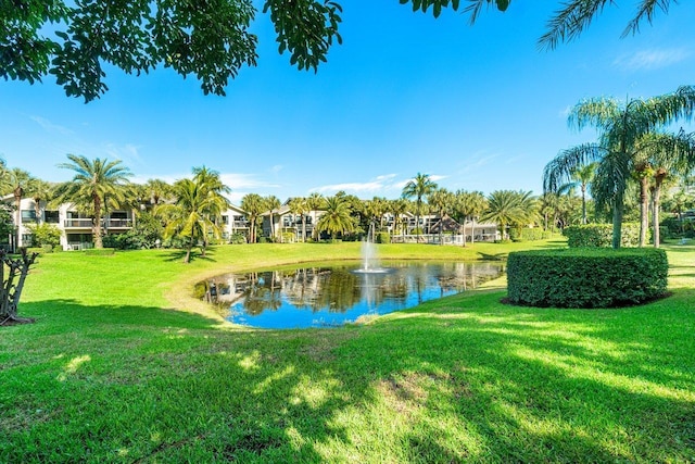 view of home's community featuring a yard and a water view