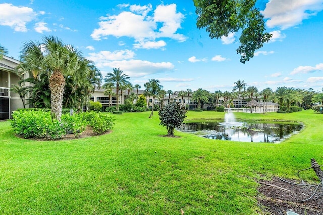 surrounding community with a yard and a water view