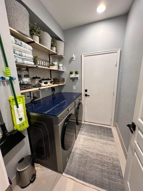 laundry room with separate washer and dryer and light tile patterned floors