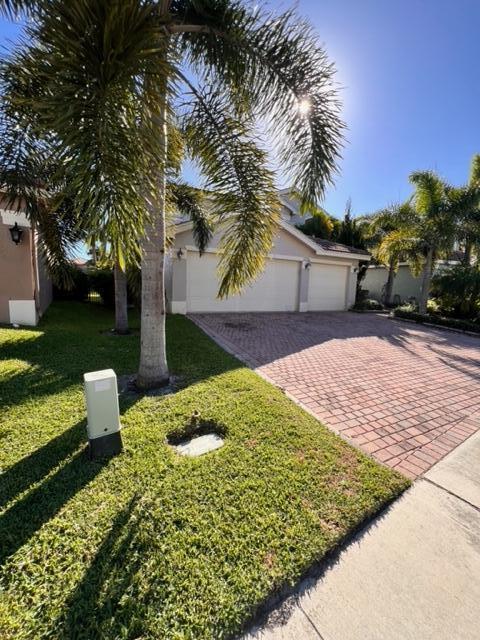 view of front of house with a garage and a front yard