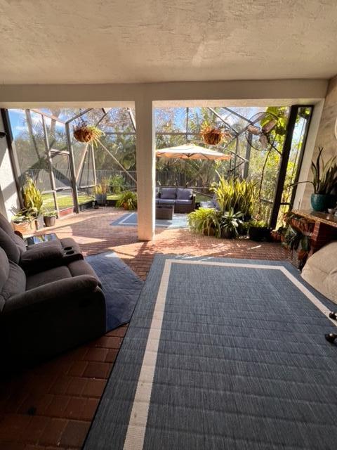 view of patio with outdoor lounge area and a lanai