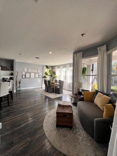 living room with plenty of natural light and hardwood / wood-style floors