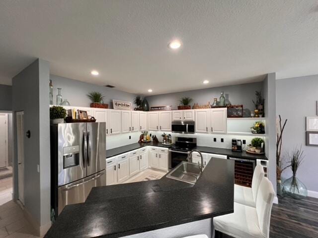 kitchen featuring white cabinetry, stainless steel appliances, and sink