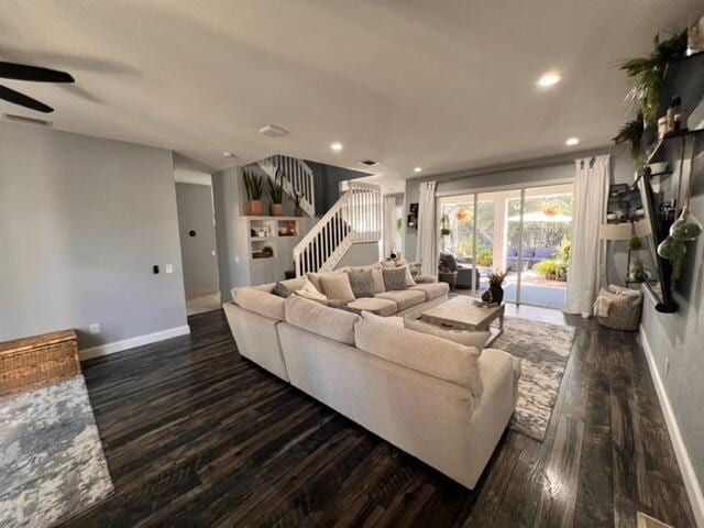 living room with dark hardwood / wood-style flooring and ceiling fan