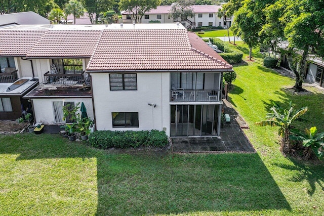 back of property featuring a lawn