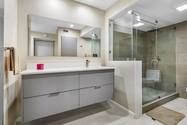 bathroom with walk in shower, toilet, tile patterned floors, and vanity