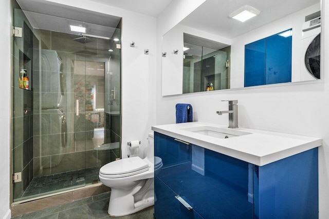 bathroom featuring toilet, vanity, an enclosed shower, and tile patterned flooring