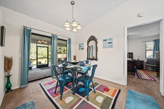 dining area with a notable chandelier, vaulted ceiling, a textured ceiling, and carpet flooring