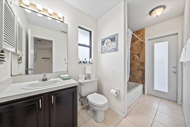 full bathroom with shower / bath combo, tile patterned flooring, vanity, a textured ceiling, and toilet