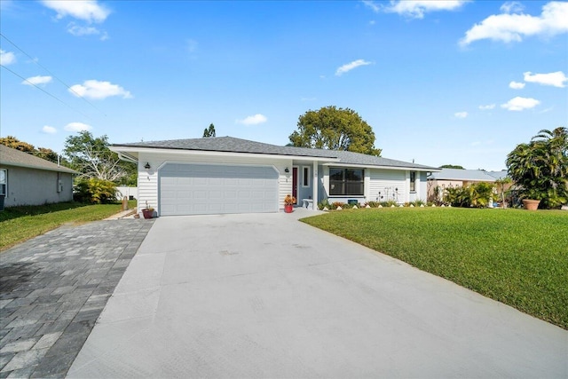 single story home featuring a garage and a front lawn