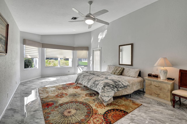 bedroom with visible vents, baseboards, lofted ceiling, a textured wall, and marble finish floor