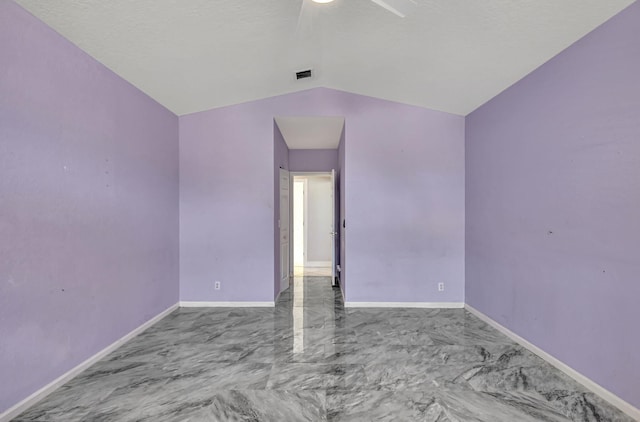 spare room featuring visible vents, lofted ceiling, marble finish floor, a ceiling fan, and baseboards