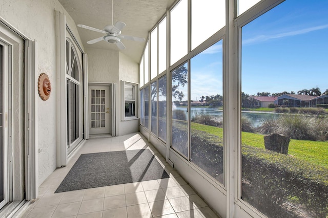 sunroom with a water view and a ceiling fan