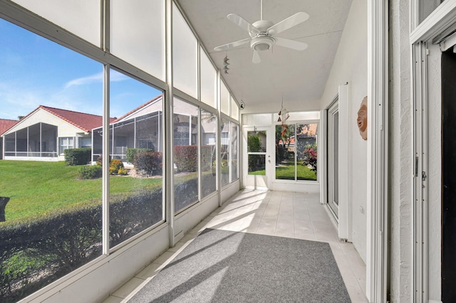 unfurnished sunroom featuring vaulted ceiling and a ceiling fan