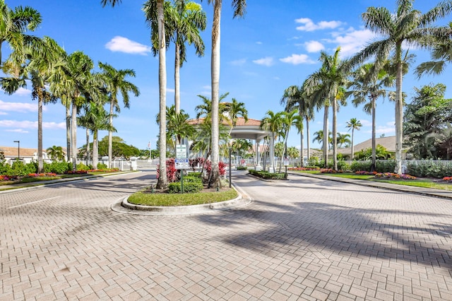 view of street featuring a gate, curbs, and a gated entry