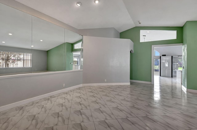 spare room with recessed lighting, baseboards, marble finish floor, and vaulted ceiling