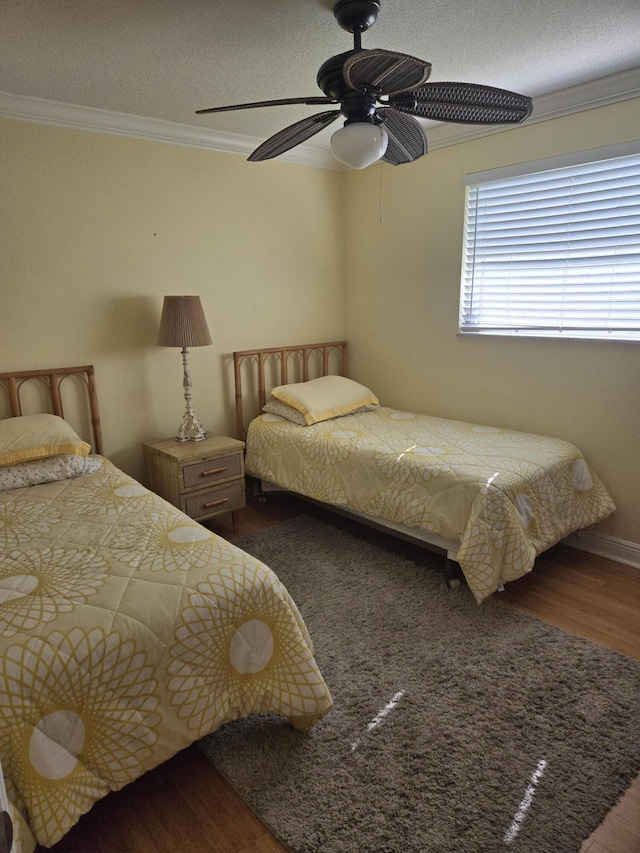 bedroom with hardwood / wood-style flooring, crown molding, a textured ceiling, and ceiling fan