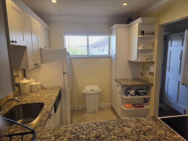 kitchen with white cabinetry, ornamental molding, sink, and backsplash