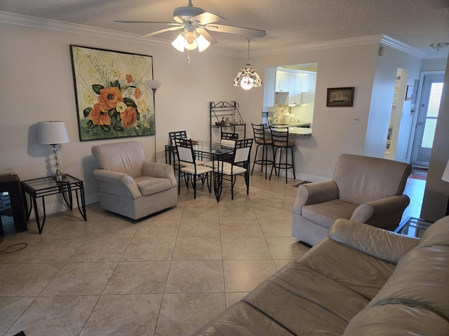 tiled living room featuring ceiling fan, ornamental molding, and a textured ceiling