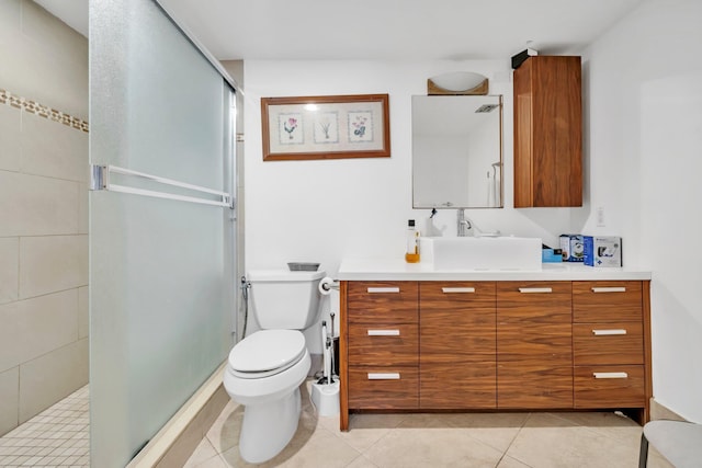 bathroom featuring toilet, tile patterned flooring, a shower with shower door, and vanity