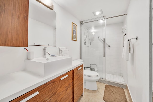 bathroom with toilet, tile patterned flooring, a shower with shower door, and vanity