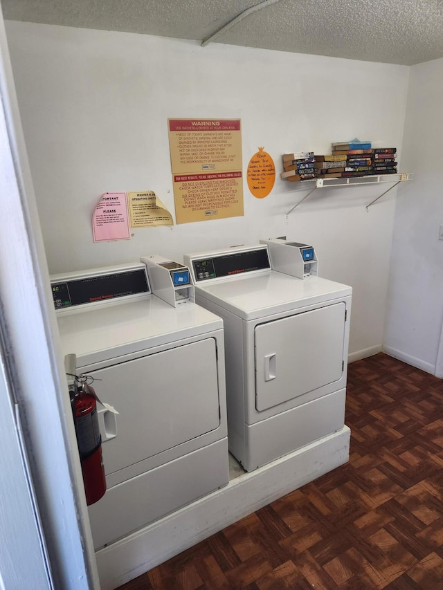 laundry room with dark parquet floors, a textured ceiling, and separate washer and dryer