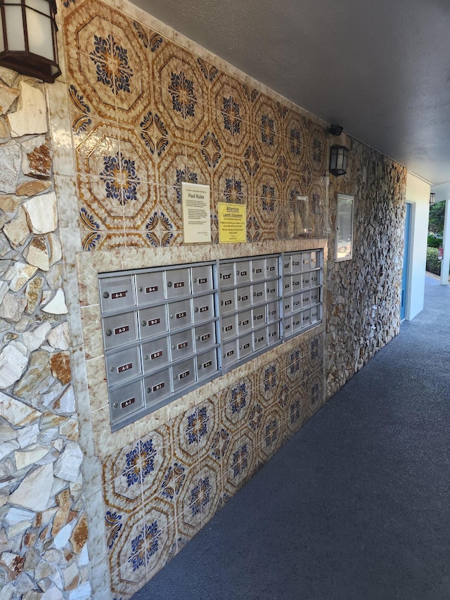 room details featuring carpet floors and a mail area