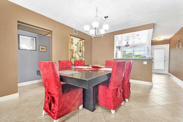 dining room featuring ceiling fan with notable chandelier and light tile patterned floors