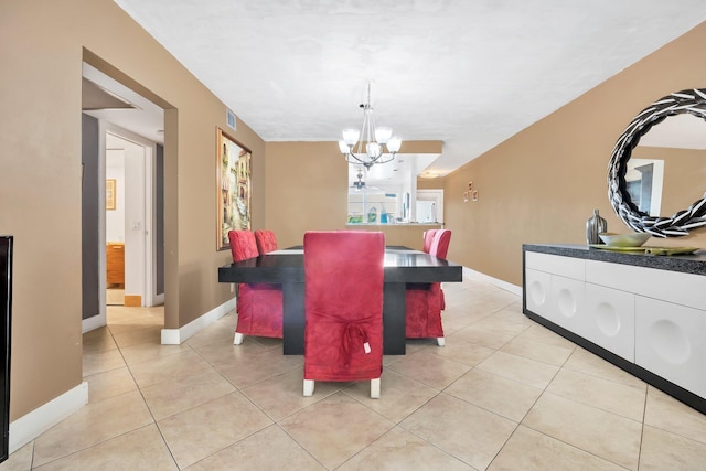 dining area featuring a notable chandelier and light tile patterned floors