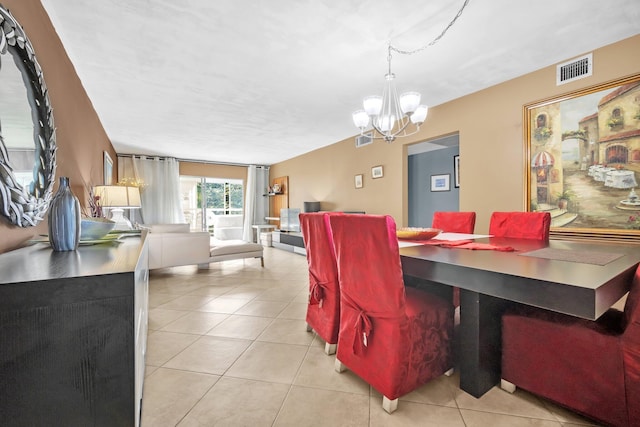 tiled dining space featuring a chandelier