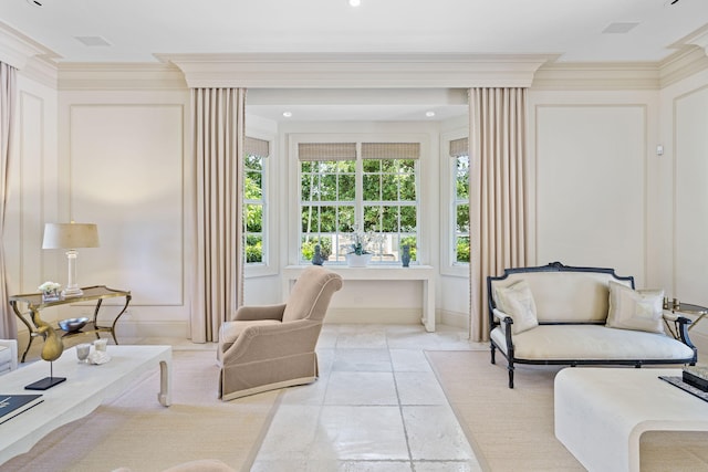 living area featuring ornamental molding