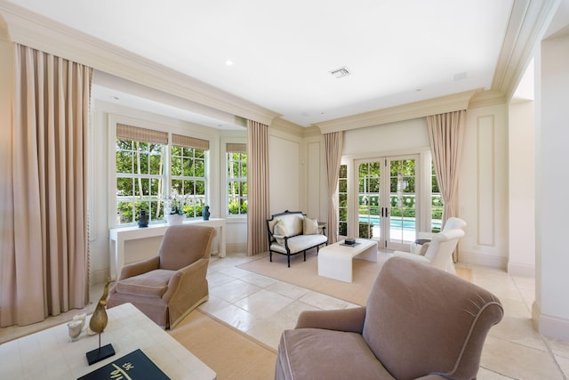 sitting room with ornamental molding, french doors, and light tile patterned flooring