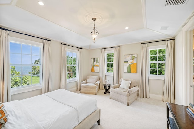 bedroom featuring multiple windows, ornamental molding, carpet floors, and a tray ceiling