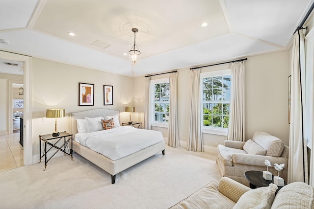 carpeted bedroom with crown molding and a raised ceiling