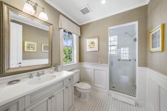 bathroom featuring an enclosed shower, vanity, crown molding, and toilet