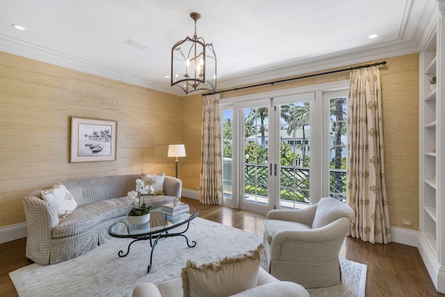 living room with dark wood-type flooring, french doors, built in features, and a chandelier