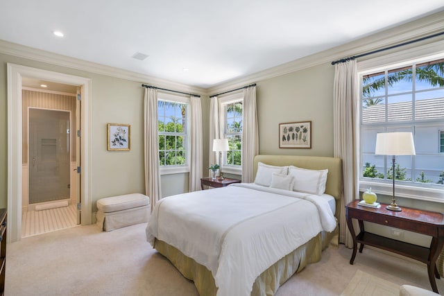 carpeted bedroom with ensuite bathroom and ornamental molding