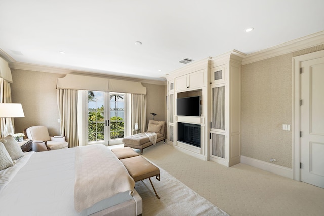 carpeted bedroom with crown molding and french doors