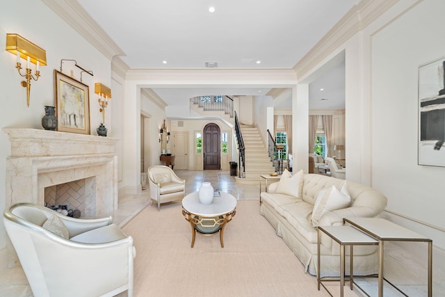 living room with crown molding and a fireplace