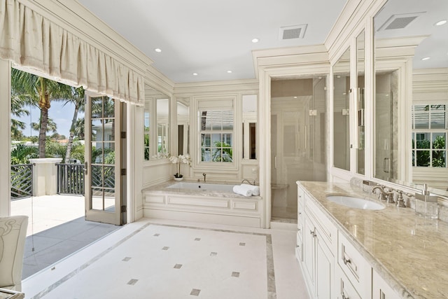 bathroom featuring plus walk in shower, tile patterned flooring, and vanity