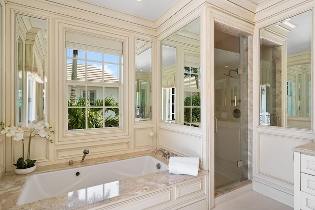 bathroom with vanity and shower with separate bathtub