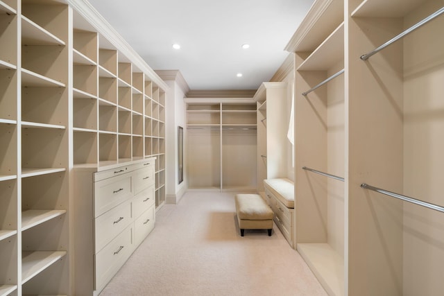 walk in closet featuring light carpet